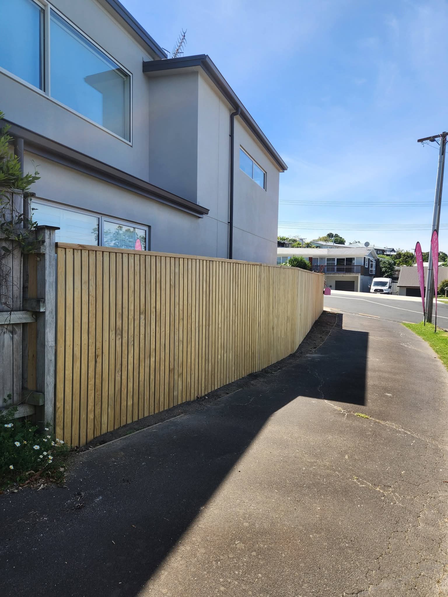 Curved timber fence along driveway